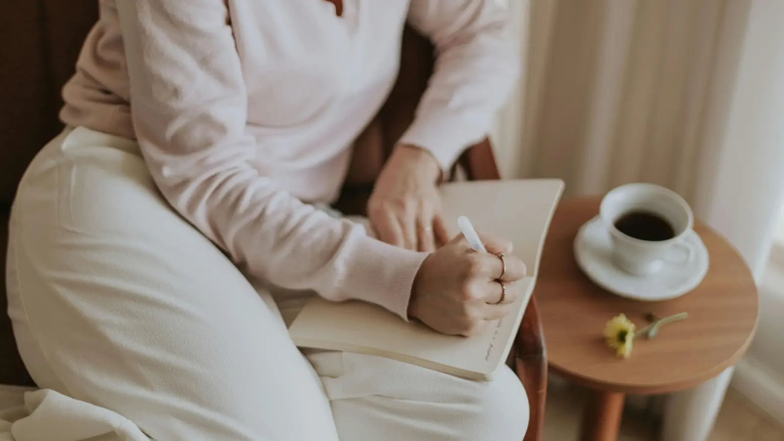 Woman journaling with coffee during a quiet moment of reflection